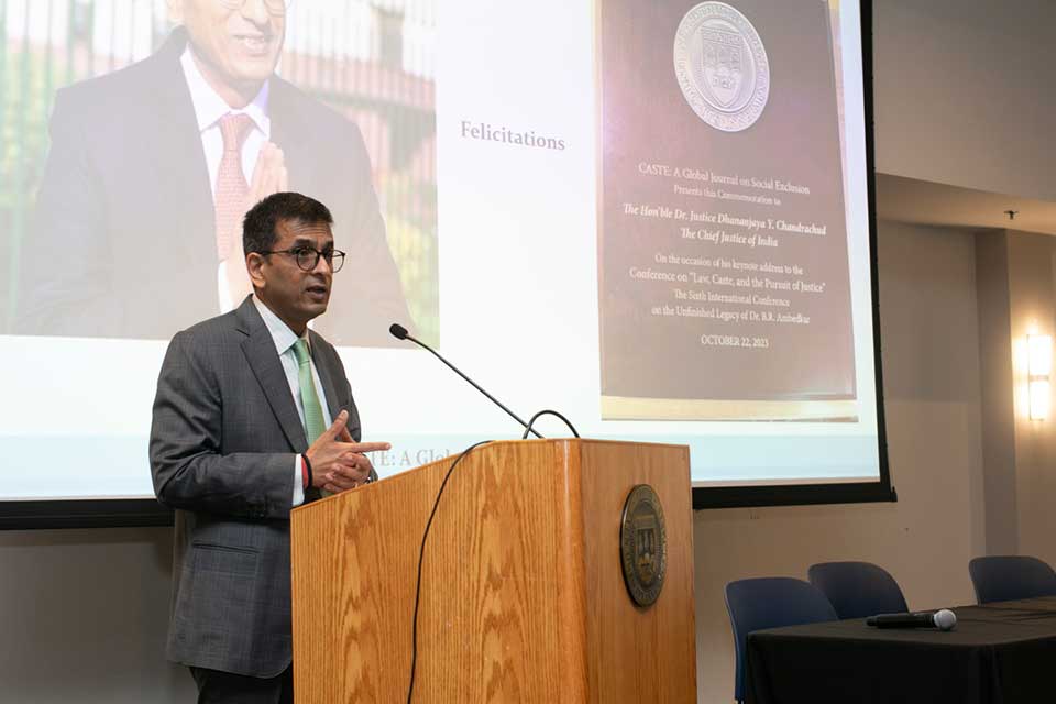 Chief Justice of India, dressed in suit and delivering a speech on a podium